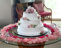 Beautiful pink roses grace this wedding cake.