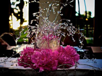 Wedding reception centerpiece with bright pink flowers and sparlkly bling