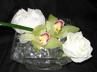 Maui orchid centerpiece with gardenias in sparkly clear bowl