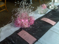 Wedding reception centerpiece table setting with bright pink flowers and sparlkly bling