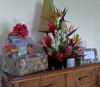 Honeymoon tropical arrangment, munchies gift basket and message in shell frame.