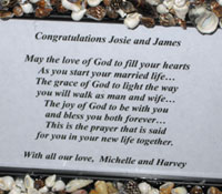 Personalized message in handmade shell frame for honeymooners.